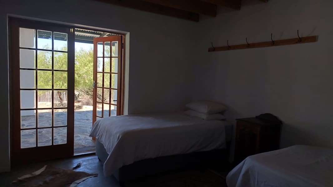 Bedroom with French doors opening onto the stoep