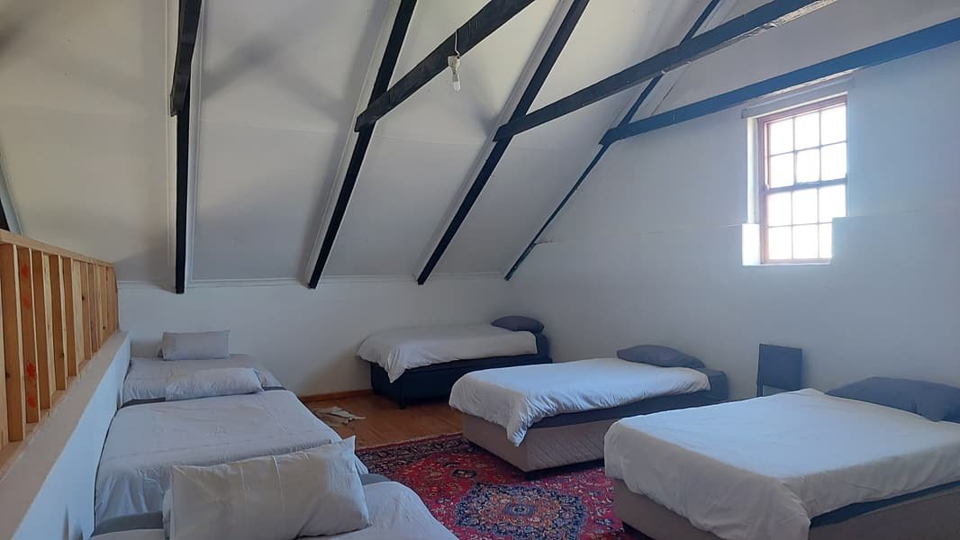 Loft dormitory with single beds under the roof trusses