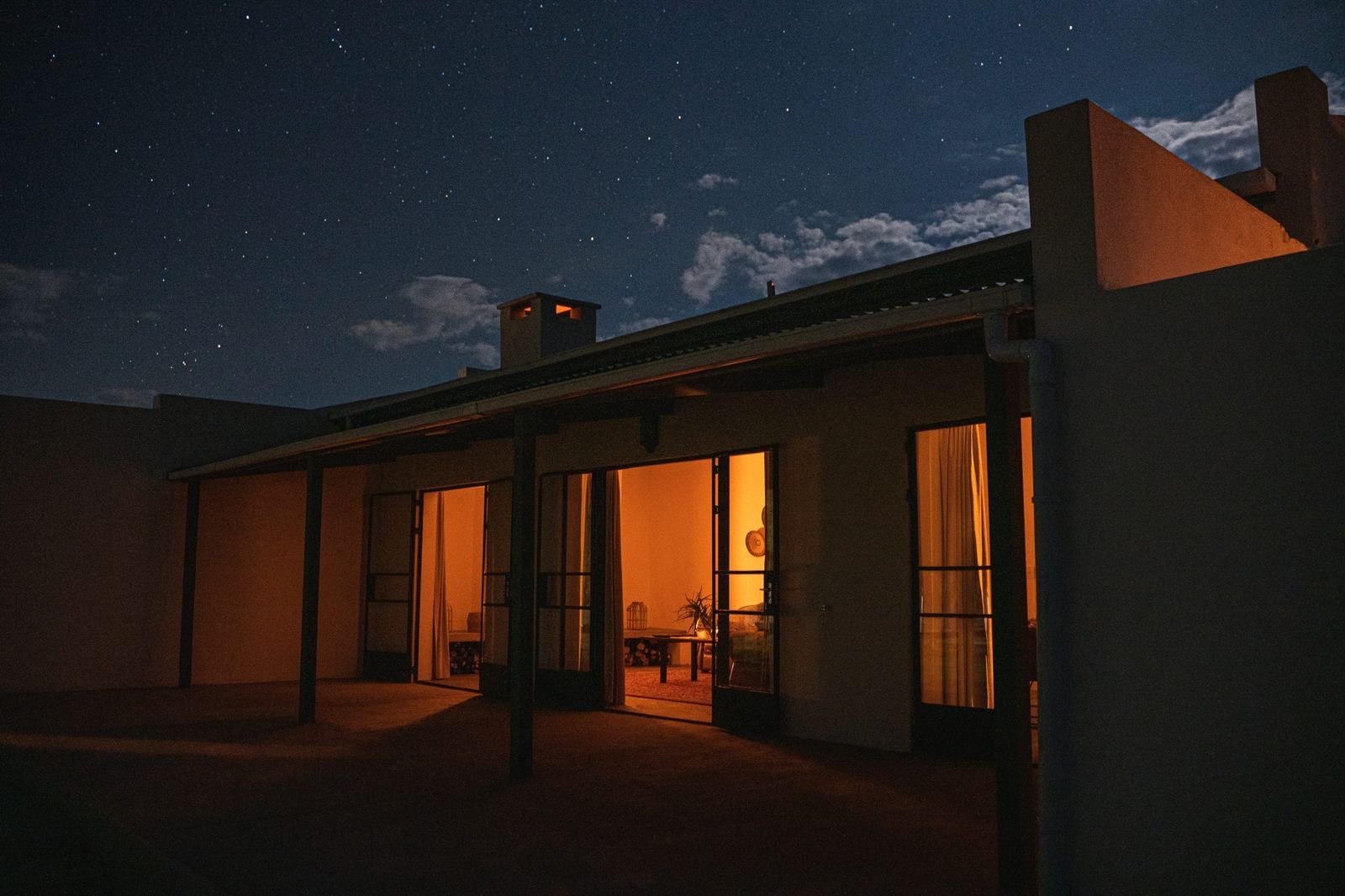 Hartsrust farm house glowing under a starry Karoo sky